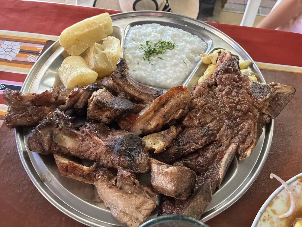 The same platter of grilled ribs and steak seen from a lower angle
