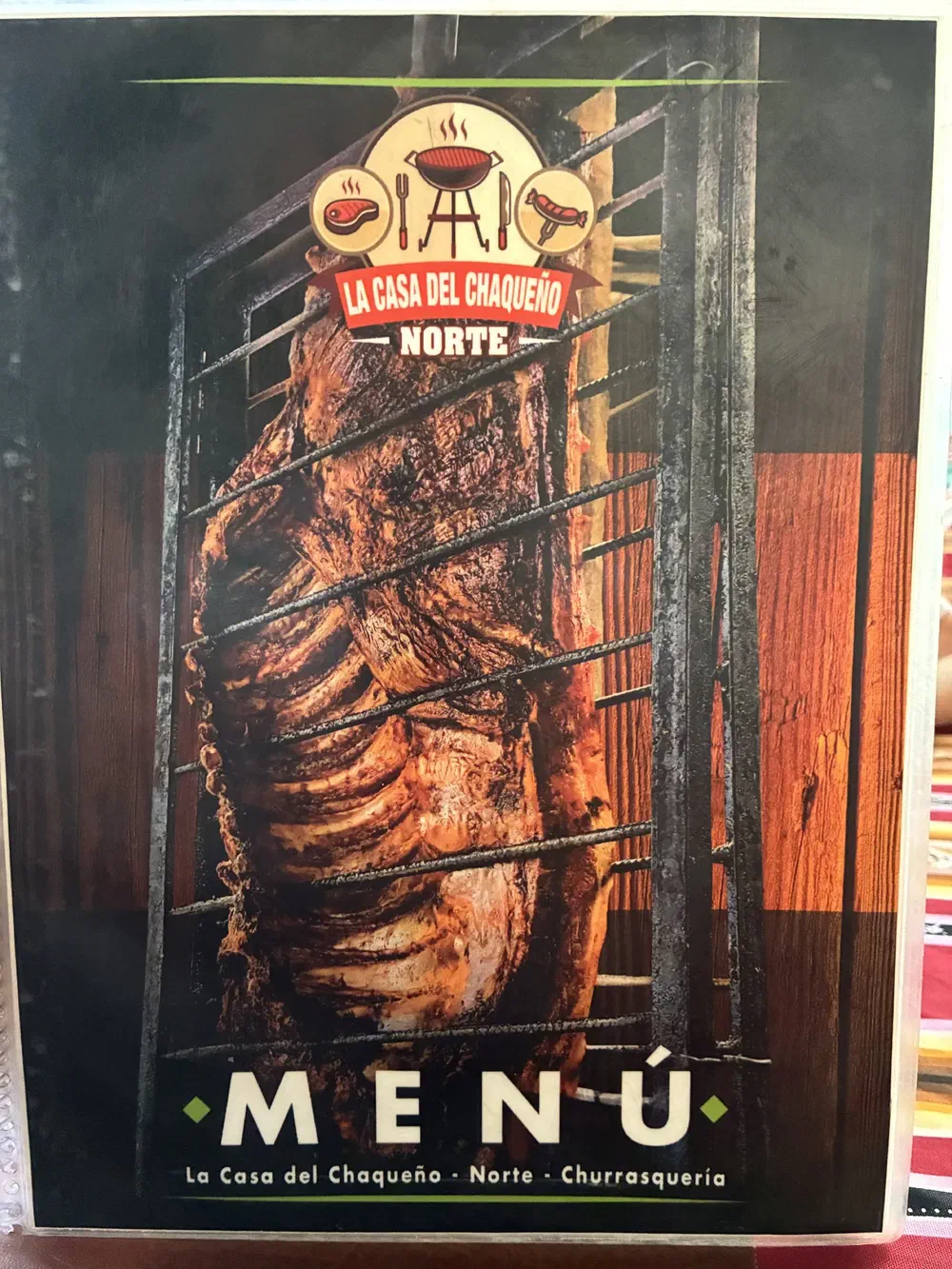 The menu cover, showing ribs cooking upright in a grill cage