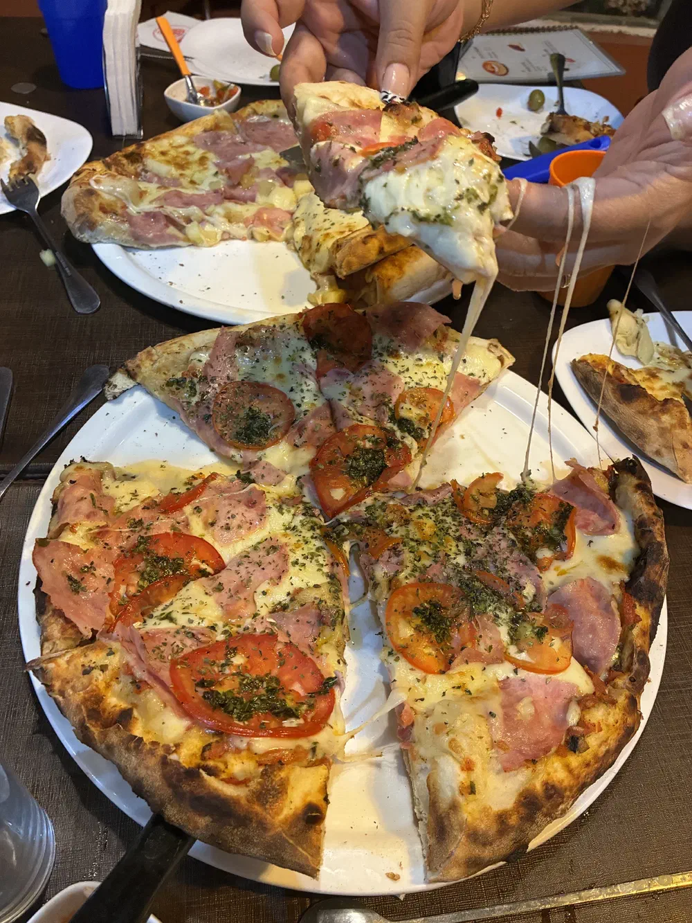 The napolitana pizza with a hawaiian pizza behind it