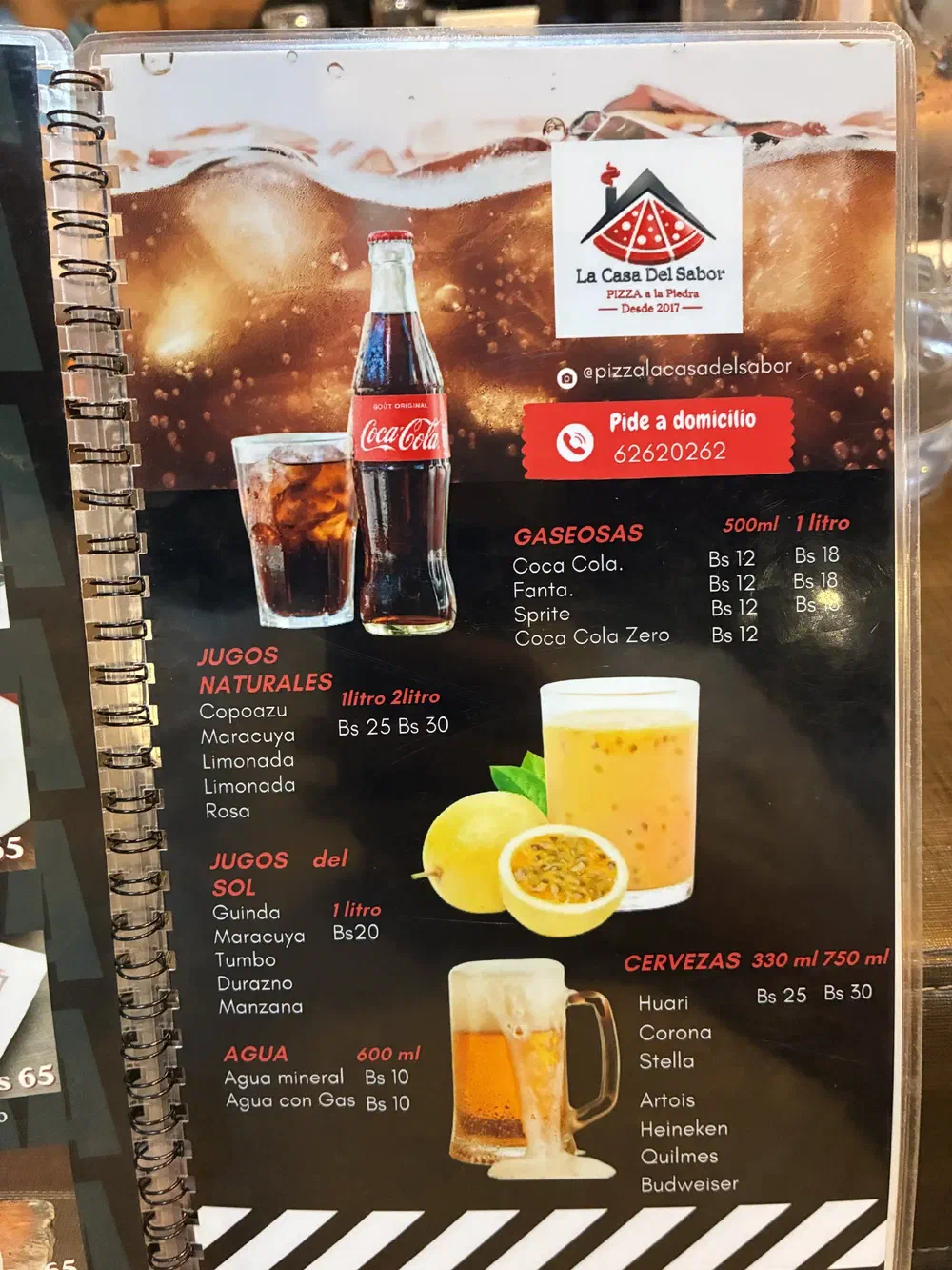 Drinks menu listing soft drinks, natural juices, water and beers, with the restaurant's delivery number
